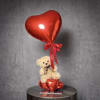 A sweet gift featuring a plush teddy bear with a red heart