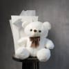 A soft and adorable white teddy bear that makes any flower delivery