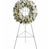 This service or visitation wreath features an elegant circular design of all-white