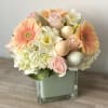 Compact Easter flower arrangement in 5&rdquo; glass cube with eggs 