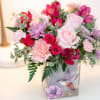 A soft blend of blush roses and delicate blooms comes together in