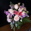 Soft blush pink roses and a show-stopping pink stargazer-style lily create a
