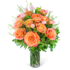 Orange roses in a clear glass vase with pink accent flowers