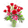 Red roses and pink lilies in a clear glass vase