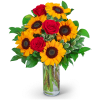 Bouquet of red roses and yellow sunflowers in a clear glass vase