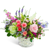 Mixed bouquet in a white wicker basket with pink roses and a white calla lily