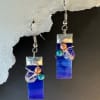 Deep cobalt blue glass drops catch the light with a sleek, modern