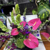 Bouquet delivered approximately as pictured with tropical blooms and lush greenery in