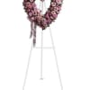 Heart-shaped pink rose wreath on a standing easel with ribbon