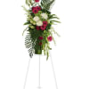 Tall standing floral spray with pink and white blooms on an easel