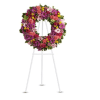 Colorful floral wreath on a white easel stand
