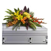 Colorful floral spray on a silver casket