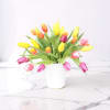 A lively cascade of yellow, pink, orange and soft purple tulips creates