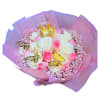 Bouquet of pink and white roses with gold butterflies and a small crown in pink wrapping
