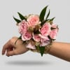 This corsage features light pink spray roses and a gold ribbon. Please