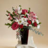 A vibrant mix of bright blossoms, featuring lush roses, delicate lilies, and
