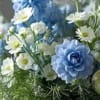 Blue and white flower arrangement with daisy-like blooms