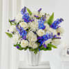 A serene basket filled with calming white and blue blooms offers a