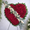 A bold, heart-shaped spray of deep red roses makes an immediate, heartfelt