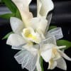 This corsage has 2 miniature calla lilies and 2 mini cymbidium orchids