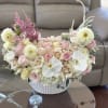 An elegant floral arrangement featuring a blend of pure white and vibrant
