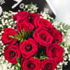 Bouquet of red roses with white baby's breath in black wrap