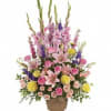 Tall mixed flower arrangement in a woven basket