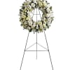 White floral funeral wreath on a standing easel