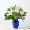 White flowers arranged in a blue glass vase
