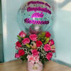 Pink rose arrangement with a clear balloon and Spanish birthday message