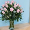 Pink roses arranged in a clear glass vase