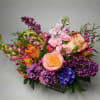 An elegant and colorful bouquet in a lush style is low and