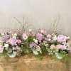 Beautiful floral arrangements in a white ceramic vase, elegant pastel colors for