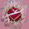 A lush ring of velvety red roses forms the heart of this