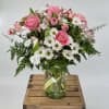 Pink roses and white daisies in a glass vase
