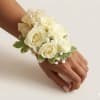 This corsage features white spray roses and a gold ribbon. Please keep
