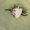  single white rose with greenery and filler and two pins