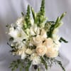 White and cream floral arrangement in a silver vase