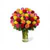 A densely clustered dome of two dozen mixed-color roses creates an immediate