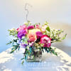 Mixed pink and purple bouquet in a square glass vase