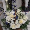 Basket arrangement of white roses and daisies with blue delphinium accents and ferns