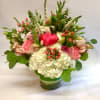 Pink and white flower arrangement with hydrangeas and roses in a clear glass cylinder vase