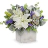 White lilies and purple flowers in a square box