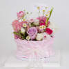 Pastel pink and lavender mixed flowers in a round pink hatbox with a thank you card.
