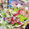 Mixed bouquet of hot pink and ivory roses with lime green blooms in white and gold wrapping