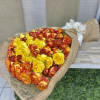 Large bouquet of yellow and orange-red roses wrapped in burlap with a white bow.