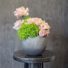A soft and elegant arrangement of blush roses paired with fresh green