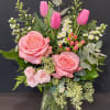 A cheerful mix of soft pink roses, tulips, spray roses, dainty white