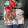 Gift basket with red roses, a teddy bear, and a heart balloon