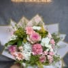 Pink and white mixed bouquet wrapped in paper
